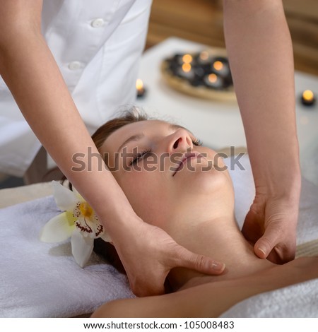 Woman getting neck massage at luxury spa centre