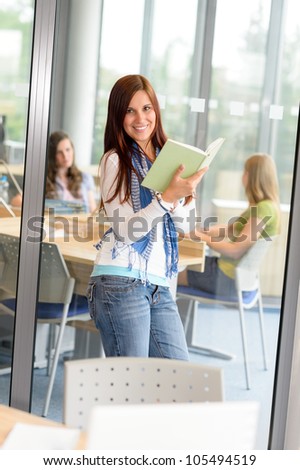 Female teenager student reading book at high school study room