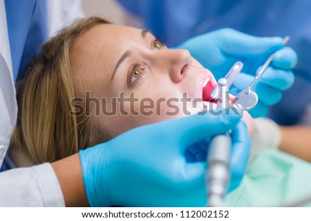 Scared patient at dentist office have teeth checkup dental tools
