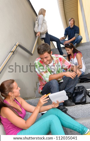 Students talking relaxing on school steps teens break smiling campus