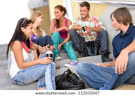 Students laughing on school stairs in break teens college relaxing