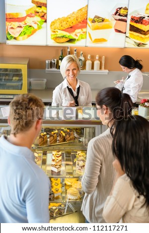 Customers waiting in line to buy dessert woman man cafe