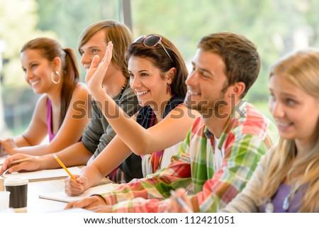 High-School Student Raising Her Hand In Class Lesson Teenagers Study