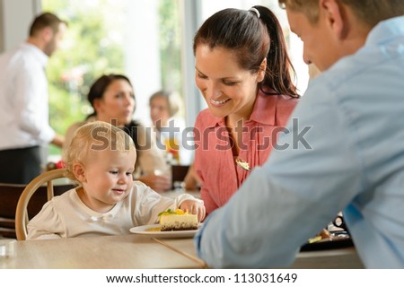 Mother and father with child eating cake woman man cafe