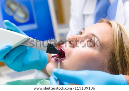 Woman with open mouth and dental tools  have teeth checkup
