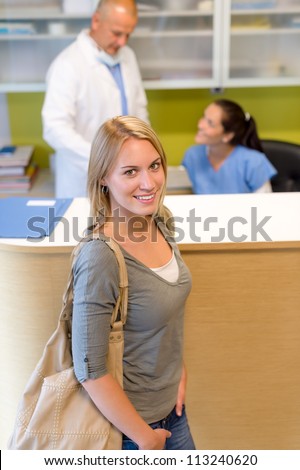 Female patient coming to dental surgery check-up appointment reception