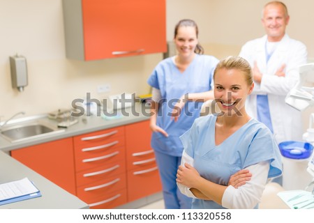 Team of dentist and nurses posing at dental surgery