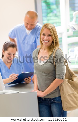 Female patient coming to dental surgery check-up appointment reception