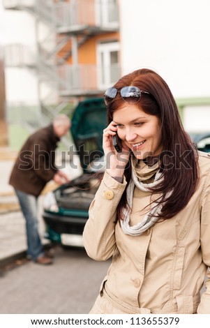 Woman on the phone repairman fixing car breakdown crash problem