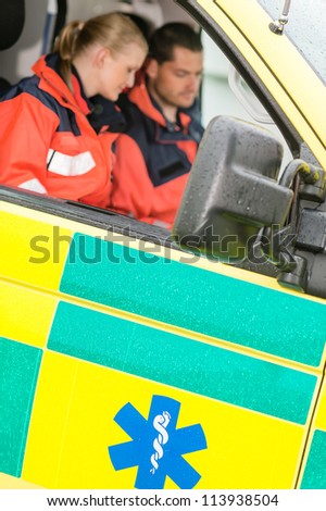 Emergency ambulance car paramedics sitting  medical work female doctor