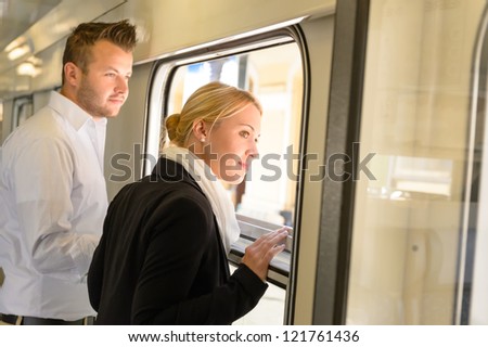 Woman and man looking out train window smiling commuters journey