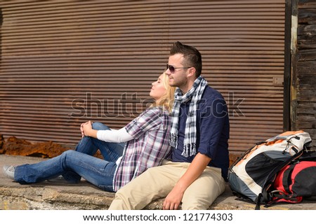 Couple resting backpack travel tired sitting trip woman man tourists