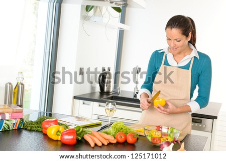 Young woman cutting vegetables kitchen preparing housework food