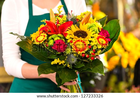 Florist holding bouquet colorful flowers shop assistant hands