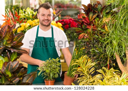 Happy male florist working flower gardening shop market assistant
