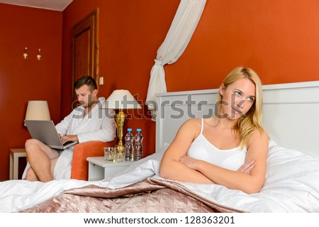 Resentful girl sitting bed room after fight boyfriend