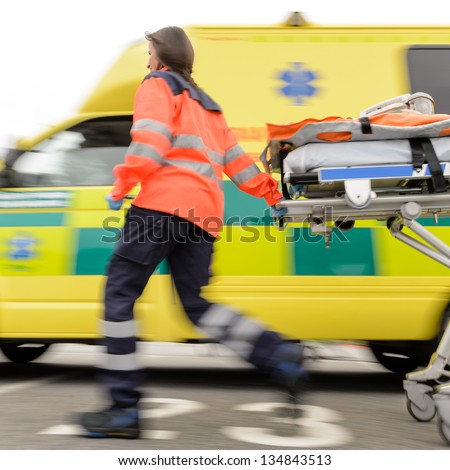 Running Blurry Paramedic Woman Rolling Stretcher Outside Of Ambulance Car