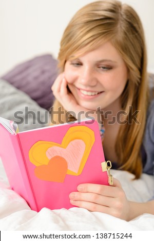 Friendly young girl reading her journal of memories