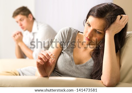 Sad wife looking at her ring after fight with husband