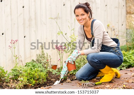 Smiling woman autumn gardening backyard housework hobby