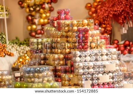 Pile of shiny Christmas balls in plastic boxes at shop