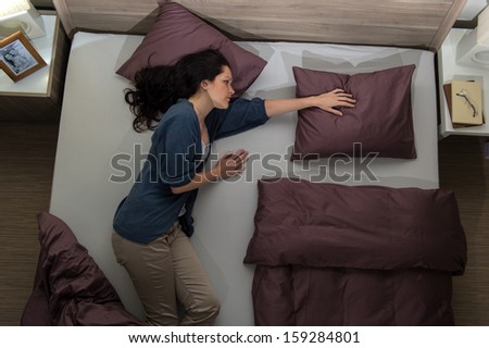 Young widow lying in bed missing her husband