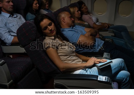 Flight passengers sleeping plane cabin night travel