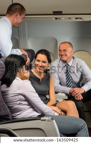 Business people passengers flying airplane talking travel flight cabin