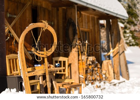 Winter snow cottage wooden sledge stand outside