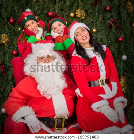 Santa Clause woman smiling elf helper sitting on Christmas armchair