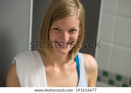 Sweaty fit woman in locker room at healthclub