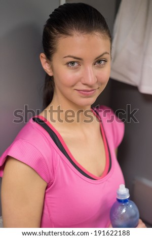 Sport woman in pink standing locker room at gym