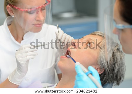 Dental team teeth checkup elderly patient woman open mouth surgery