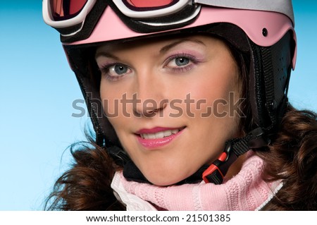 Close-up of fashion model wearing pink helmet with ski goggles