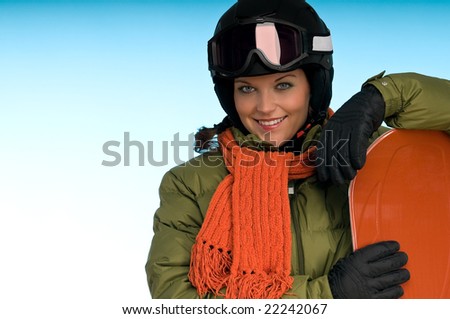 Smiling girl with orange snowboard on blue background