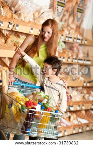 Grocery store - Red hair woman and child in a supermarket