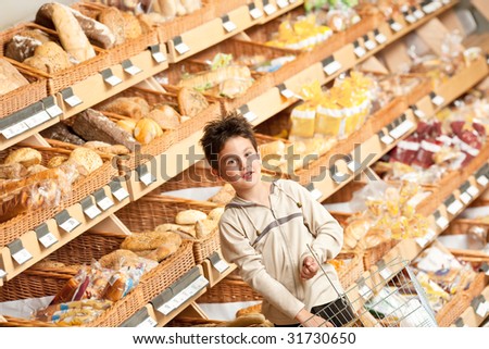 Grocery store - Little boy in a supermarket holding shopping basket
