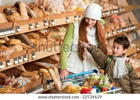 Grocery store - Red hair woman with little boy choosing bread