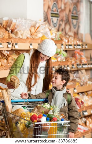 Grocery store - Red hair woman with child in a supermarket