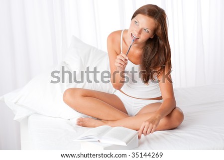 Brown hair woman with books and pen in white environment