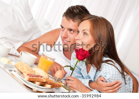 stock photo happy man and woman having luxury hotel breakfast in bed together 35992984
