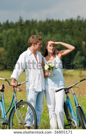 Picnic - Young couple in spring meadow