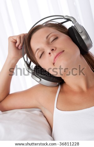 Woman with closed eyes enjoying music with headphones