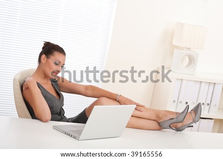 Female manager working with legs on table at the office
