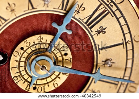 Detail of antique gold and red clock with Roman numeral, macro lens