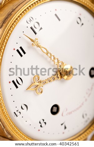 Close-up of antique gold clock with Arabic numeral, macro lens