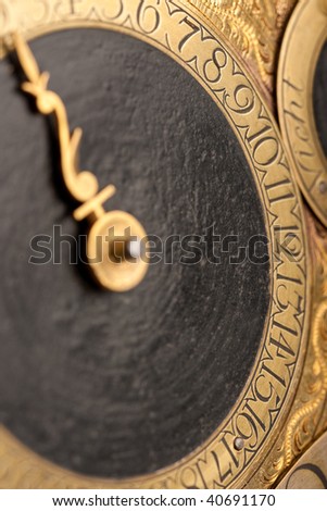 Detail of historic clock, gold and black, macro lens