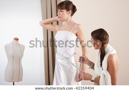 stock photo Fashion model fitting white wedding dress in professional 