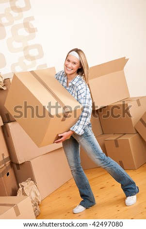 Moving house: Woman holding big carton box in new home