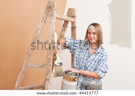 Home improvement: Smiling woman with paint and brush